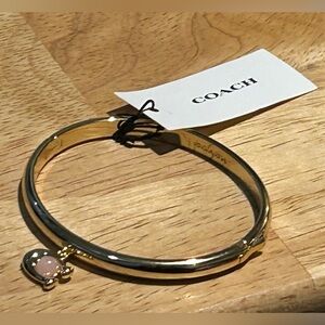 COACH Women’s Gold Logo Charm Hinged Bangle Bracelet